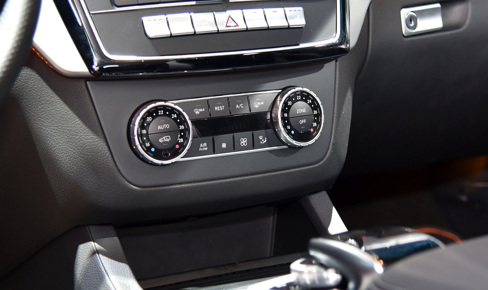 Dual temperature dials and climate control buttons in car interior