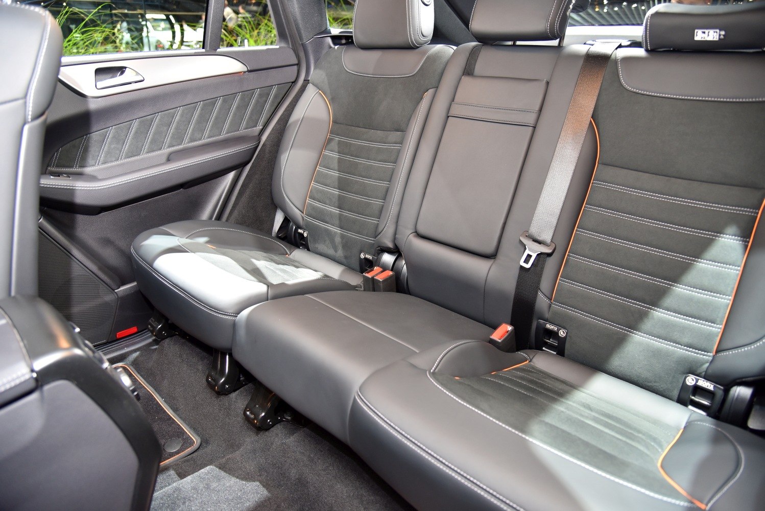 Rear seat interior leather upholstery with detailed stitching and seatbelt