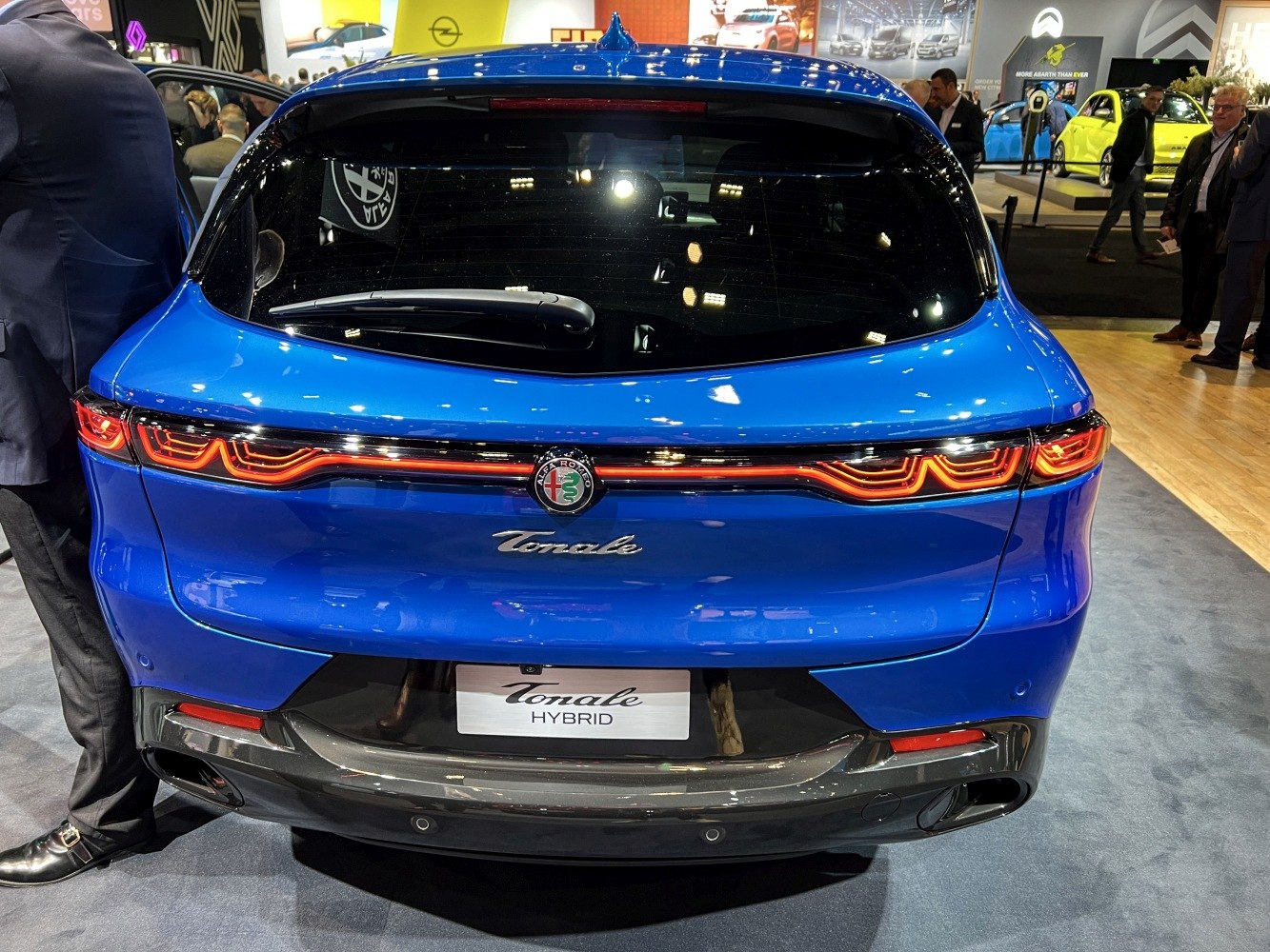 Continuous LED tail light bar and hybrid badge on rear hatch with rear windshield wiper