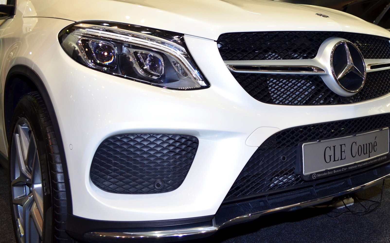 Front grille and headlight close-up of luxury coupe SUV