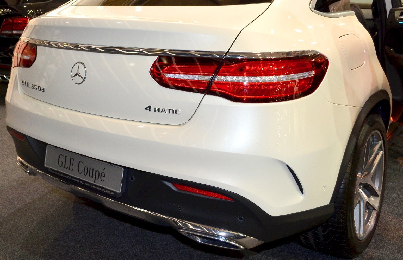 Rear design with LED tail lights and 4MATIC badge on white coupe SUV