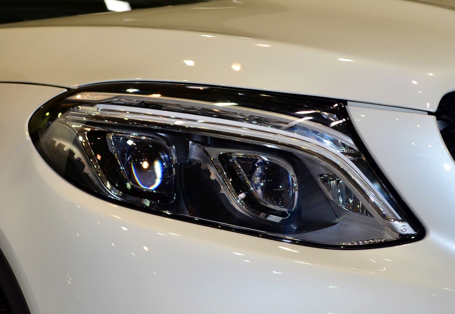 Close-up of dual projector headlight with LED strip