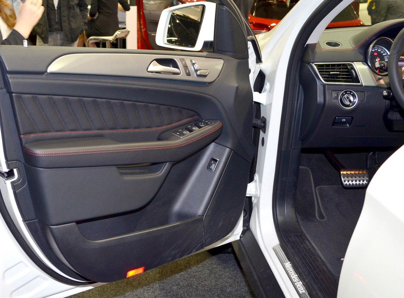 Interior door panel with stitched leather and dashboard controls