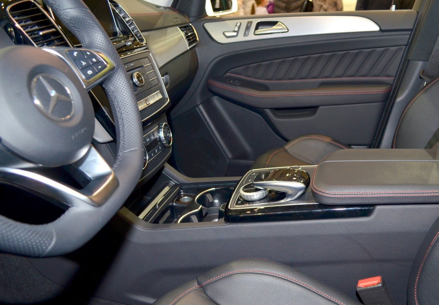 Luxury SUV interior with dashboard, steering wheel, and center console controls