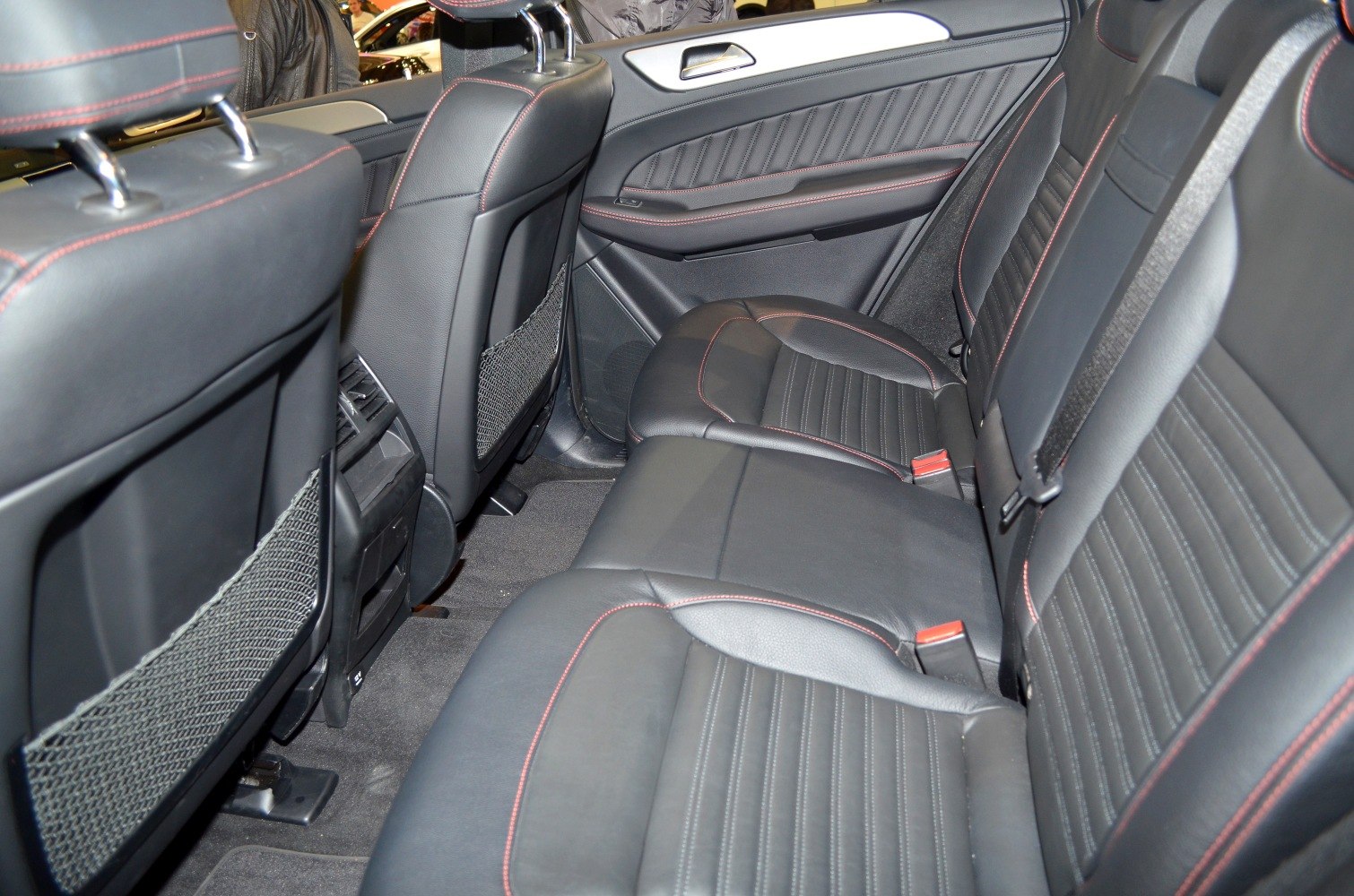 Black leather rear seats with red stitching and door panel upholstery