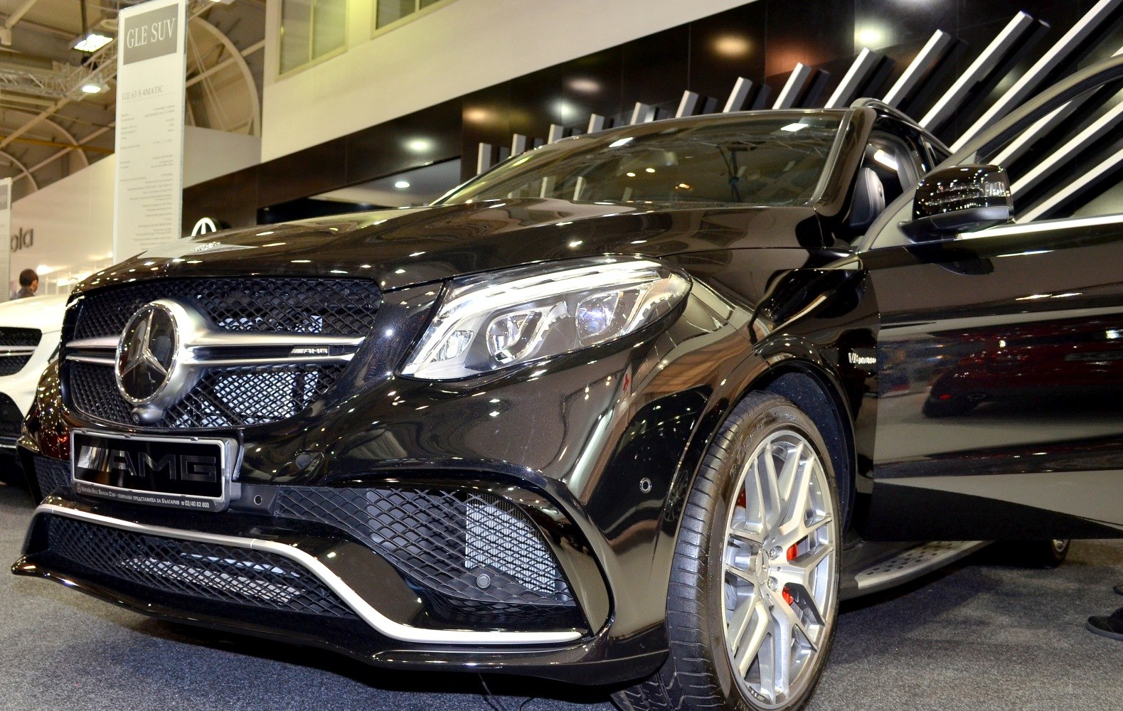 Close-up of AMG front grille and LED headlights with alloy wheels