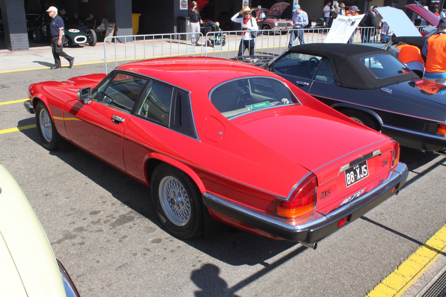 Sleek rear view of a vintage red coupe with wire spoke wheels