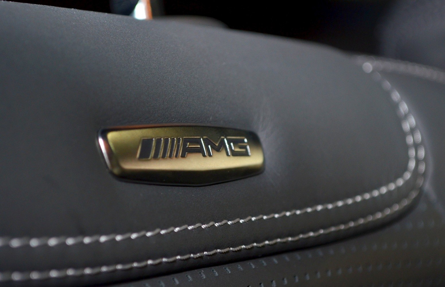AMG badge on stitched perforated leather upholstery.