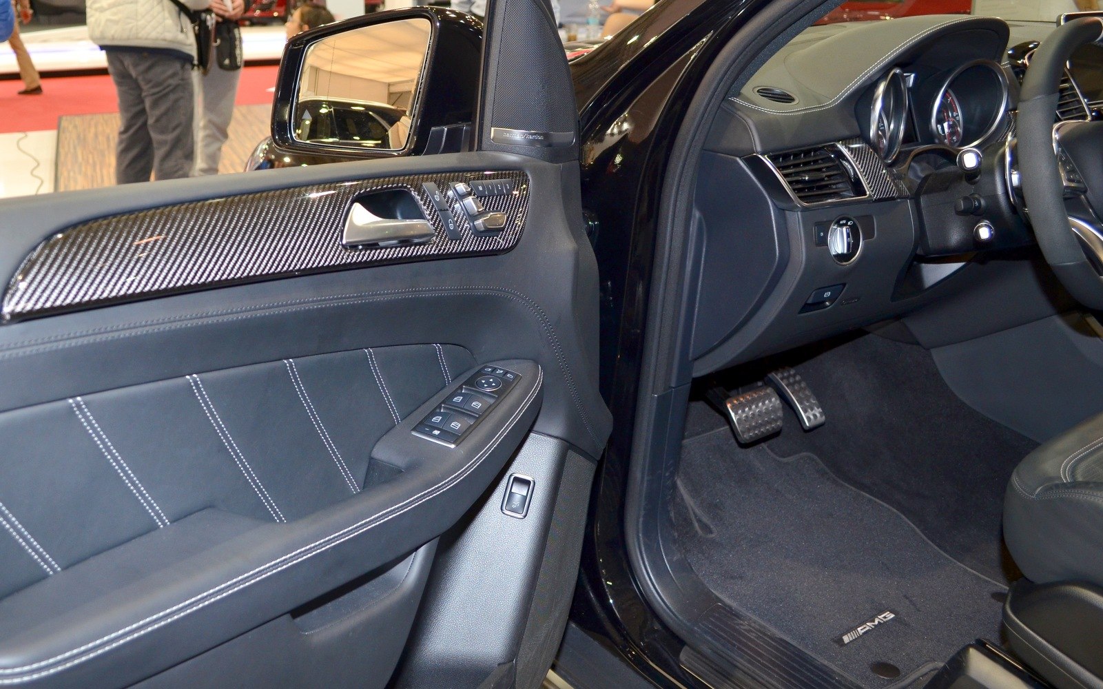 Luxury SUV interior with carbon fiber trim and detailed door controls