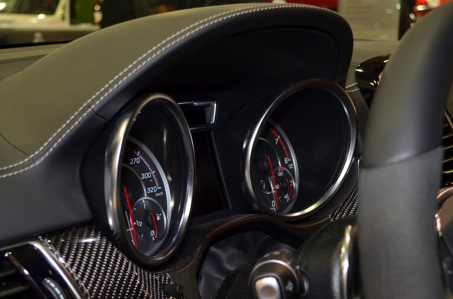 Instrument cluster with speedometer and carbon fiber dashboard trim