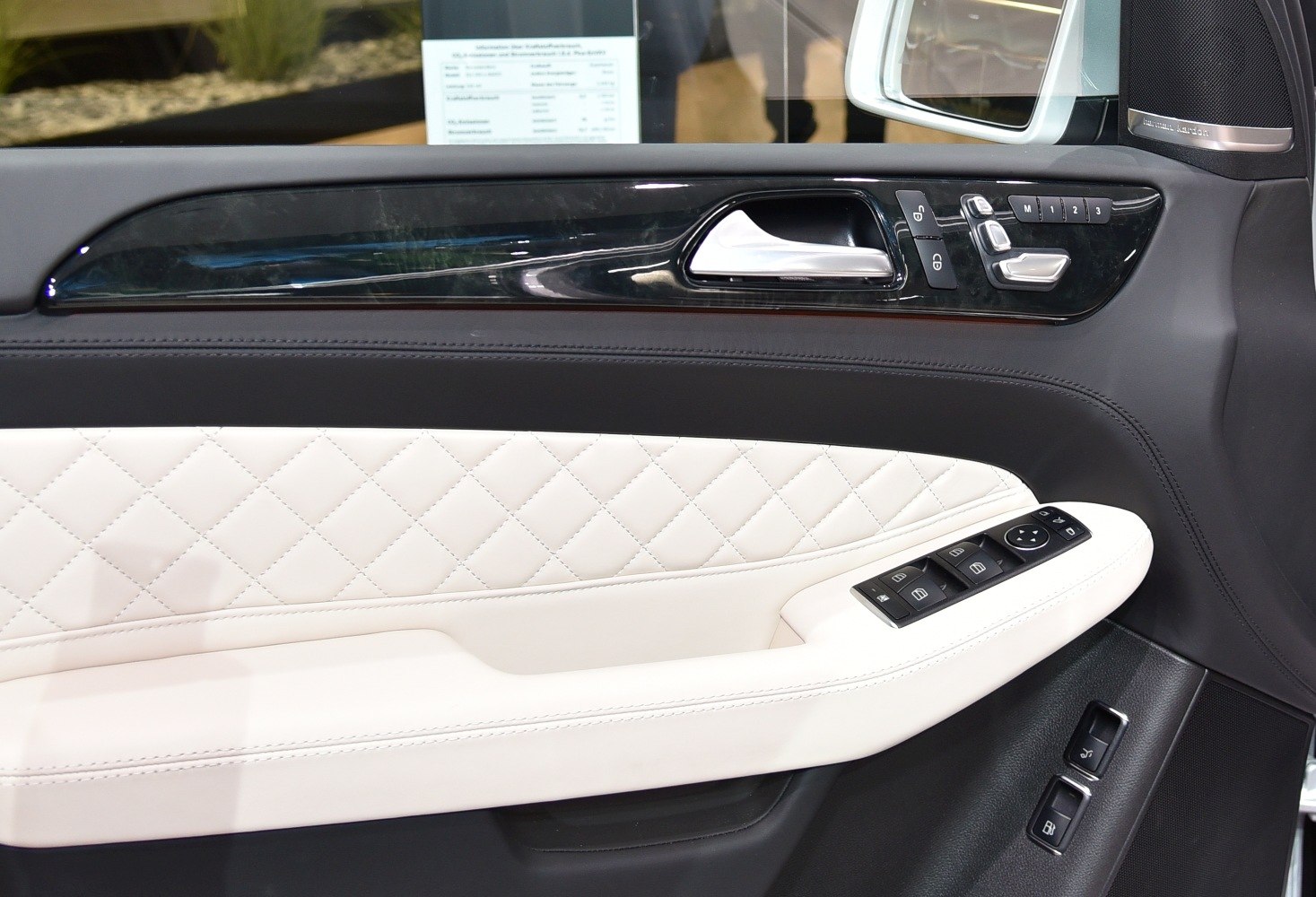 Quilted leather door panel with control buttons and premium trim