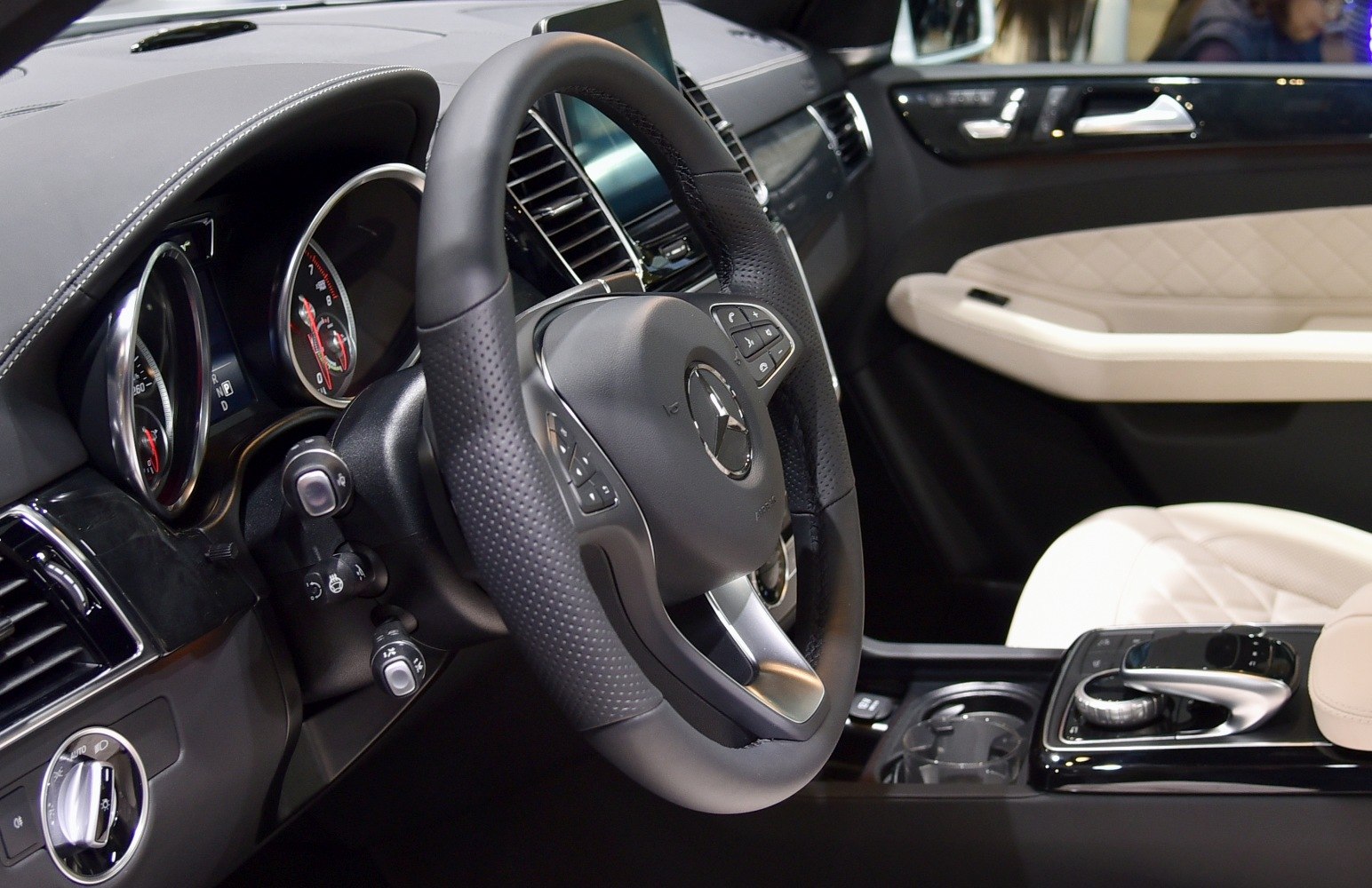 Luxury steering wheel and dashboard with control buttons and elegant interior trim