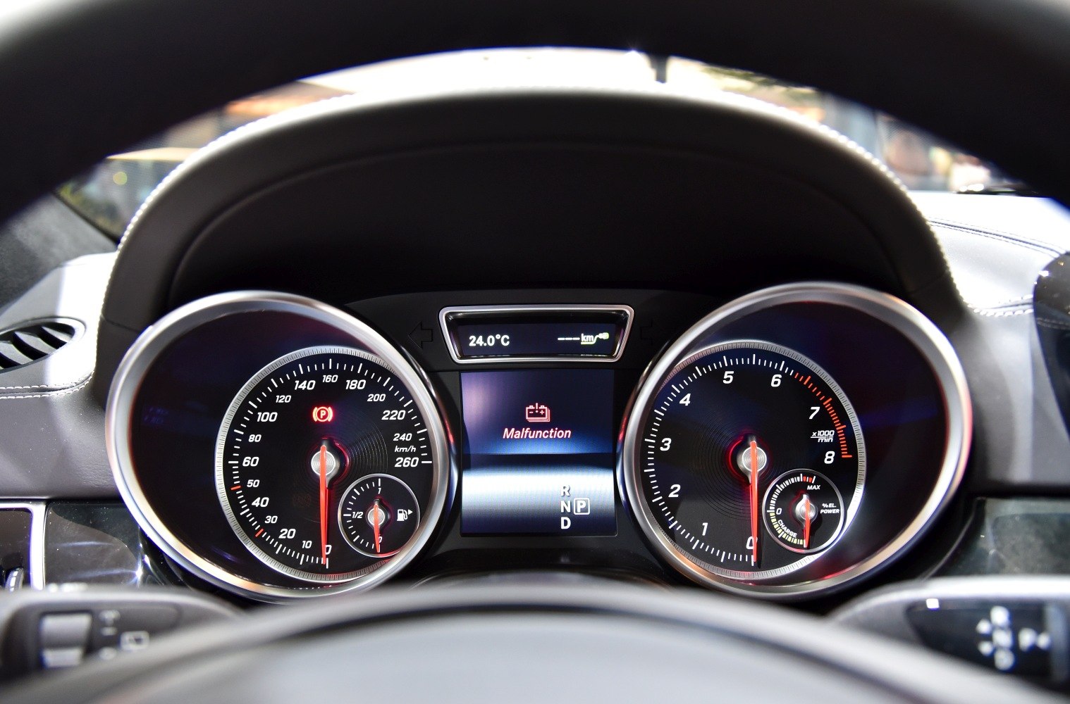 Instrument cluster with speedometer, tachometer, and malfunction warning display