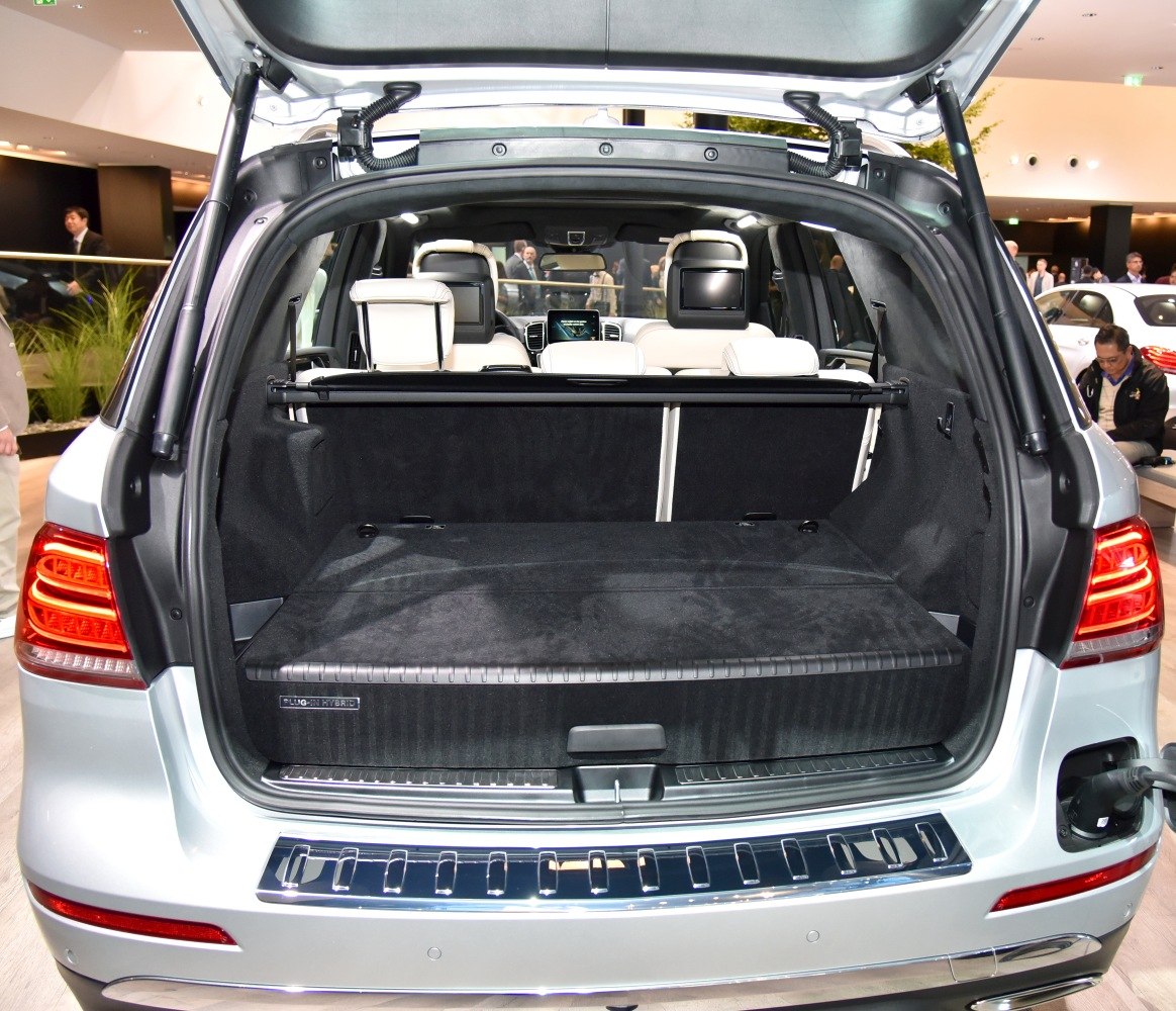 Open SUV trunk showing spacious cargo area and rear seat entertainment screens.