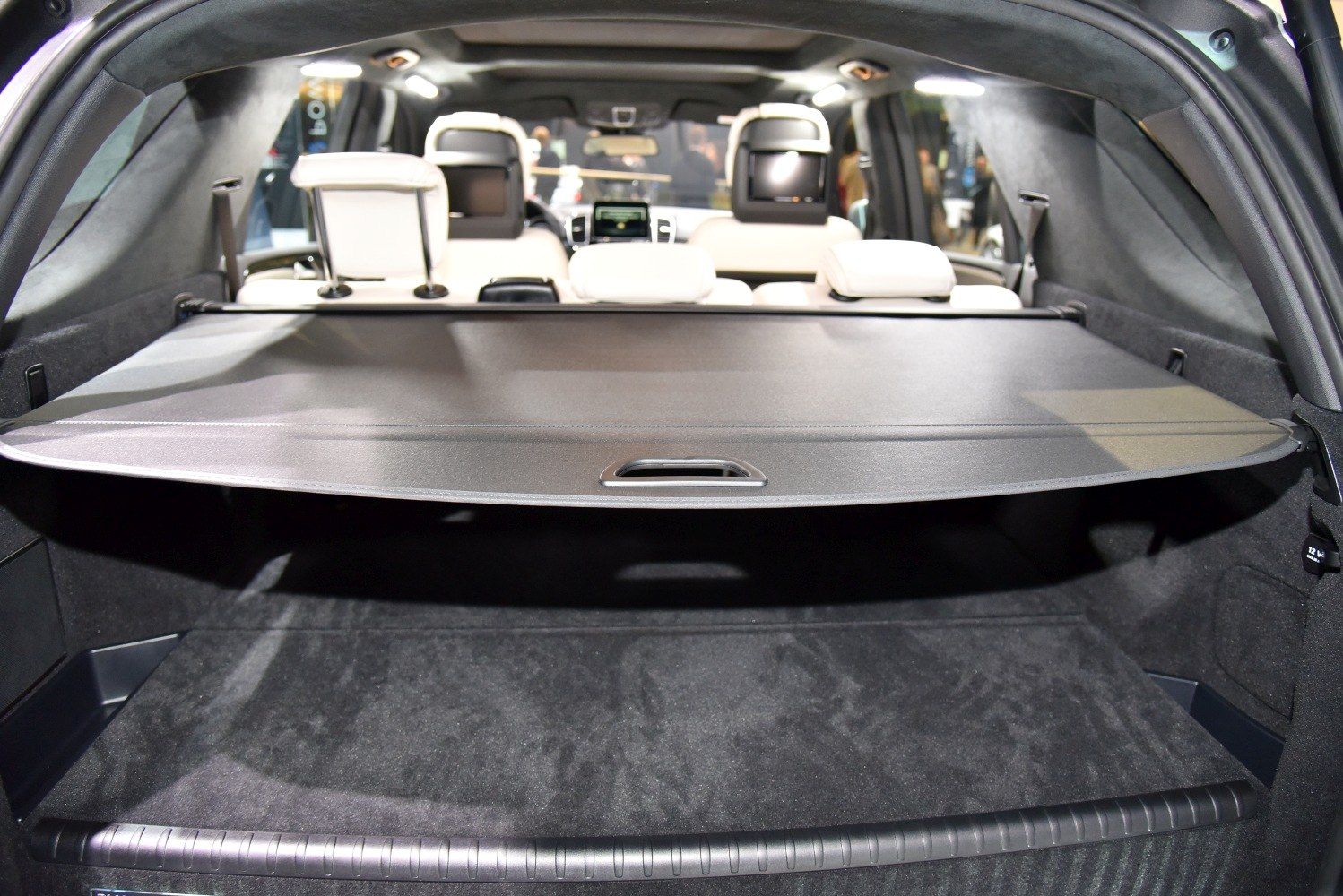 Spacious SUV cargo area with retractable cover and headrest monitors