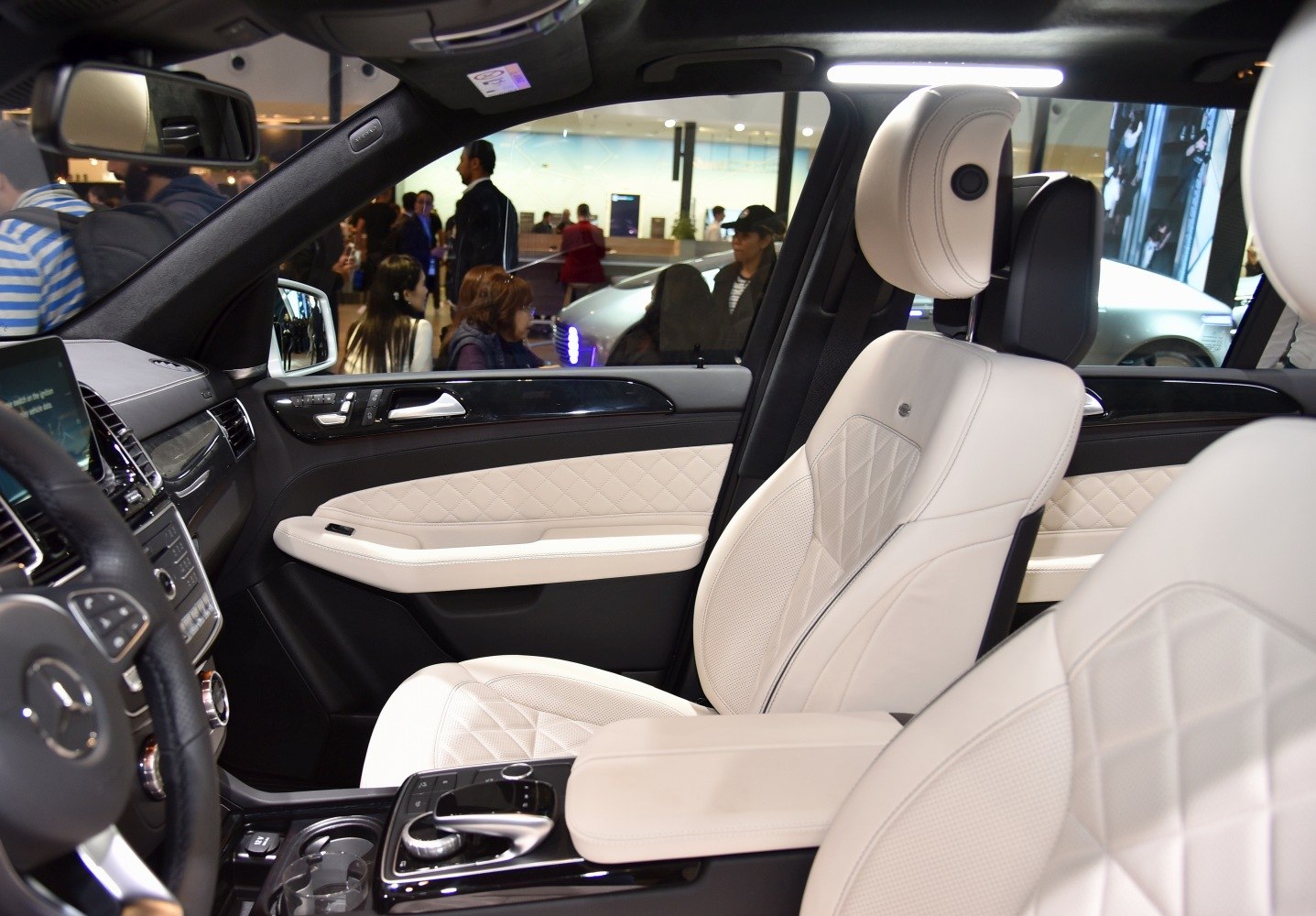White leather quilted seats and black glossy control panel.