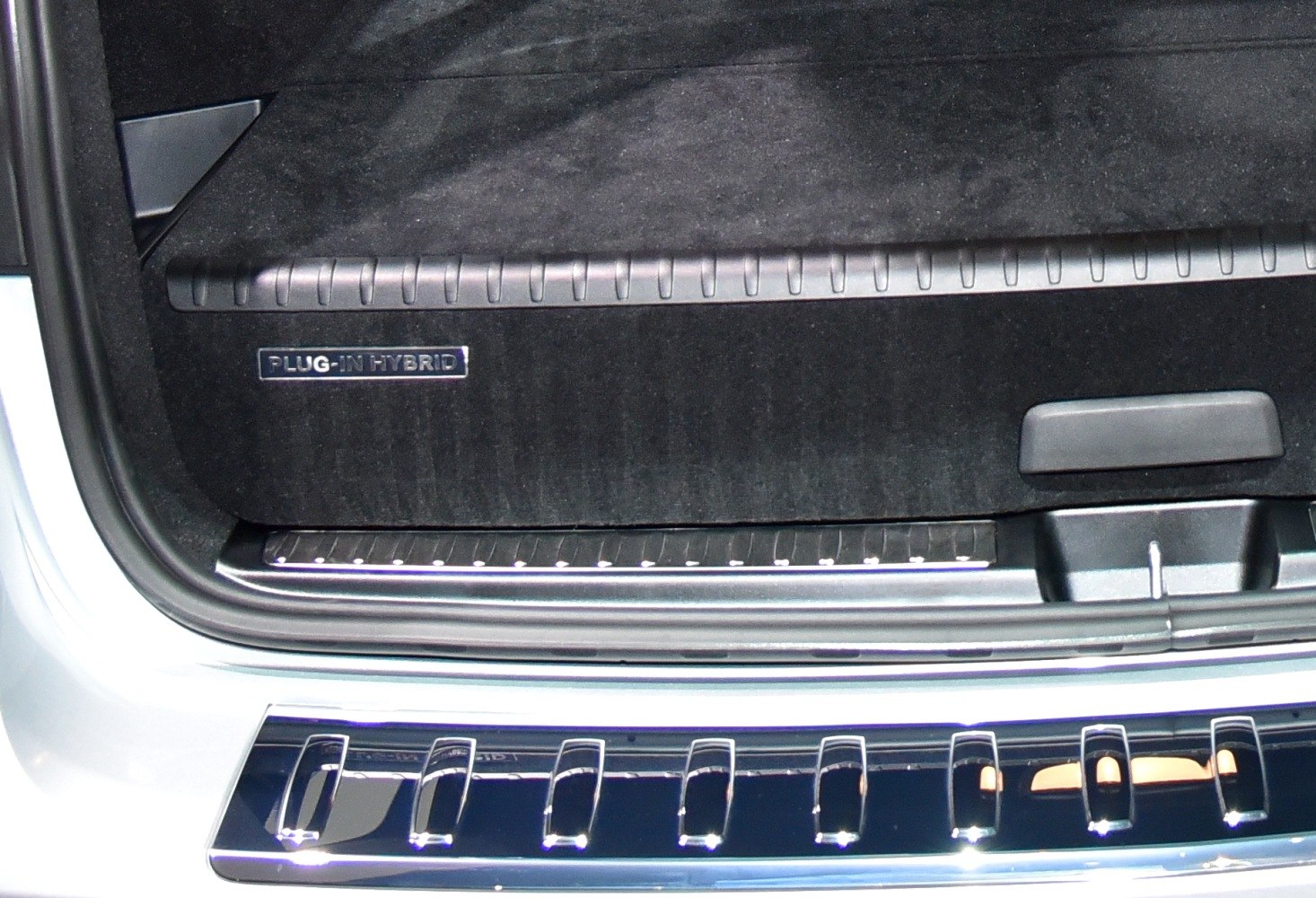 Interior rear section with Plug-In Hybrid badge and chrome trim