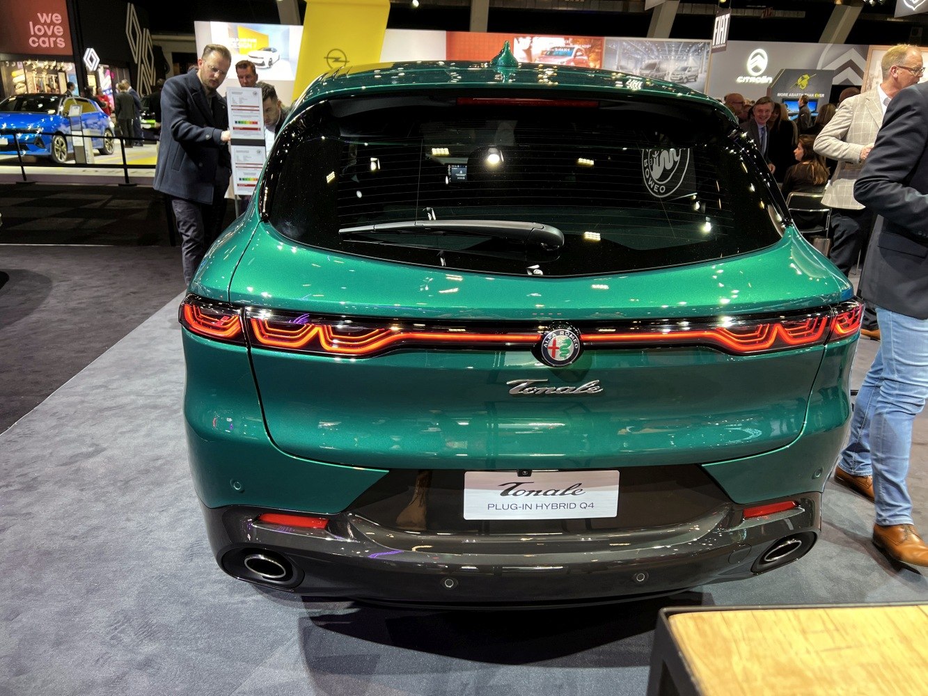 Green vehicle rear with unique wavy LED taillights and dual exhaust pipes