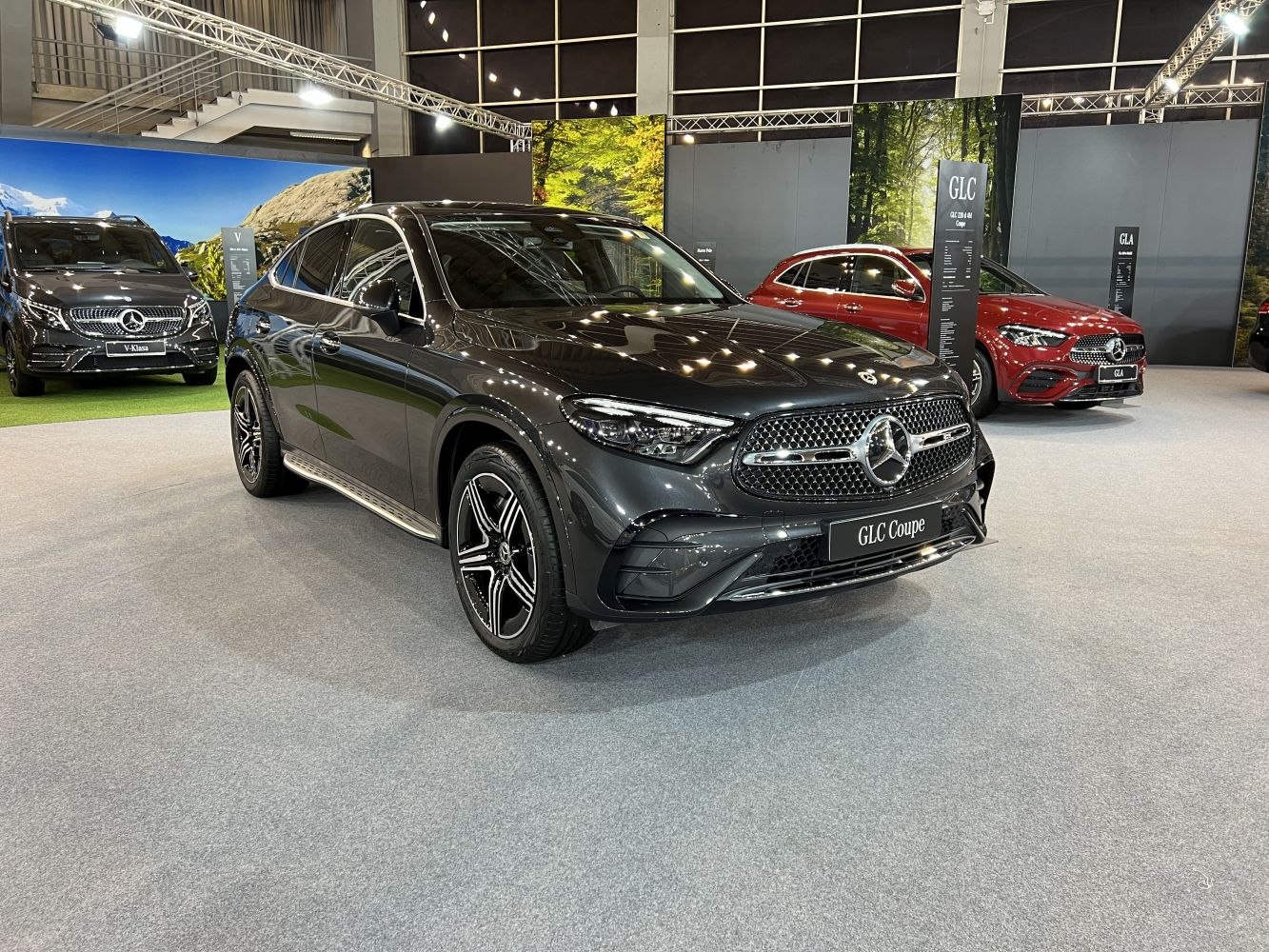 Front side view of a black luxury SUV coupe with prominent grille and alloy wheels