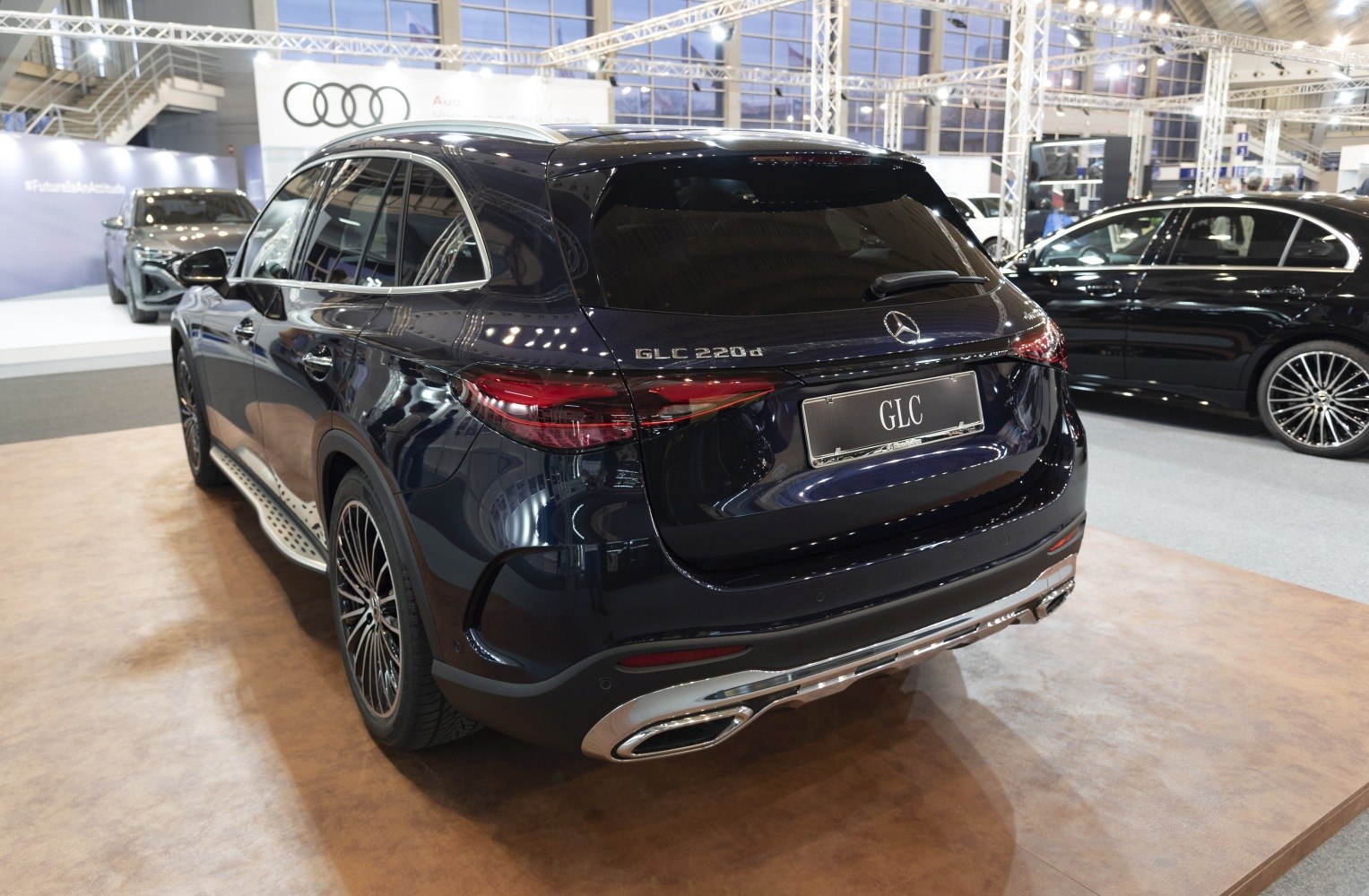 Luxury SUV rear view with LED tail lights and dual chrome exhaust tips.