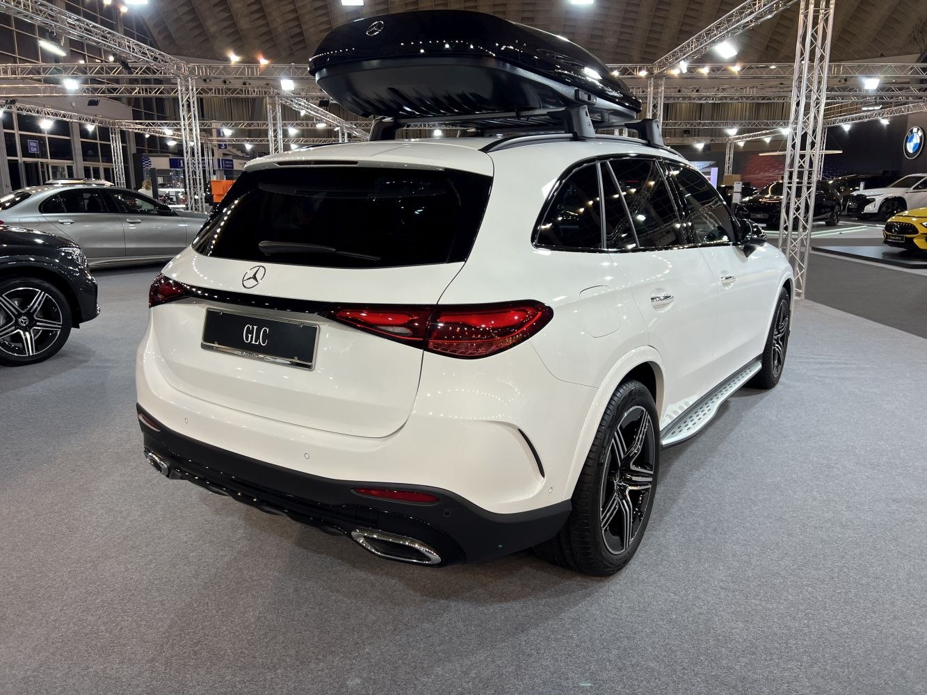 Rear view with sleek tail lights and roof storage box