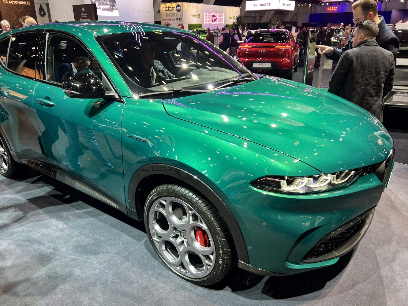Front and side of a green vehicle with distinctive wheels and headlight design