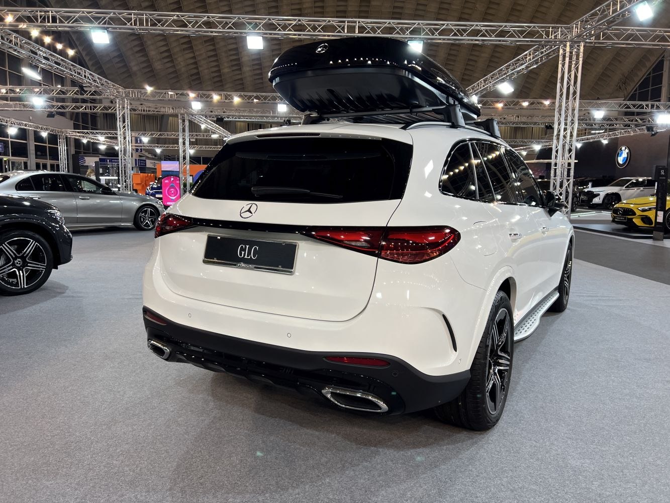 Rear view of SUV with sleek taillights and rooftop cargo box
