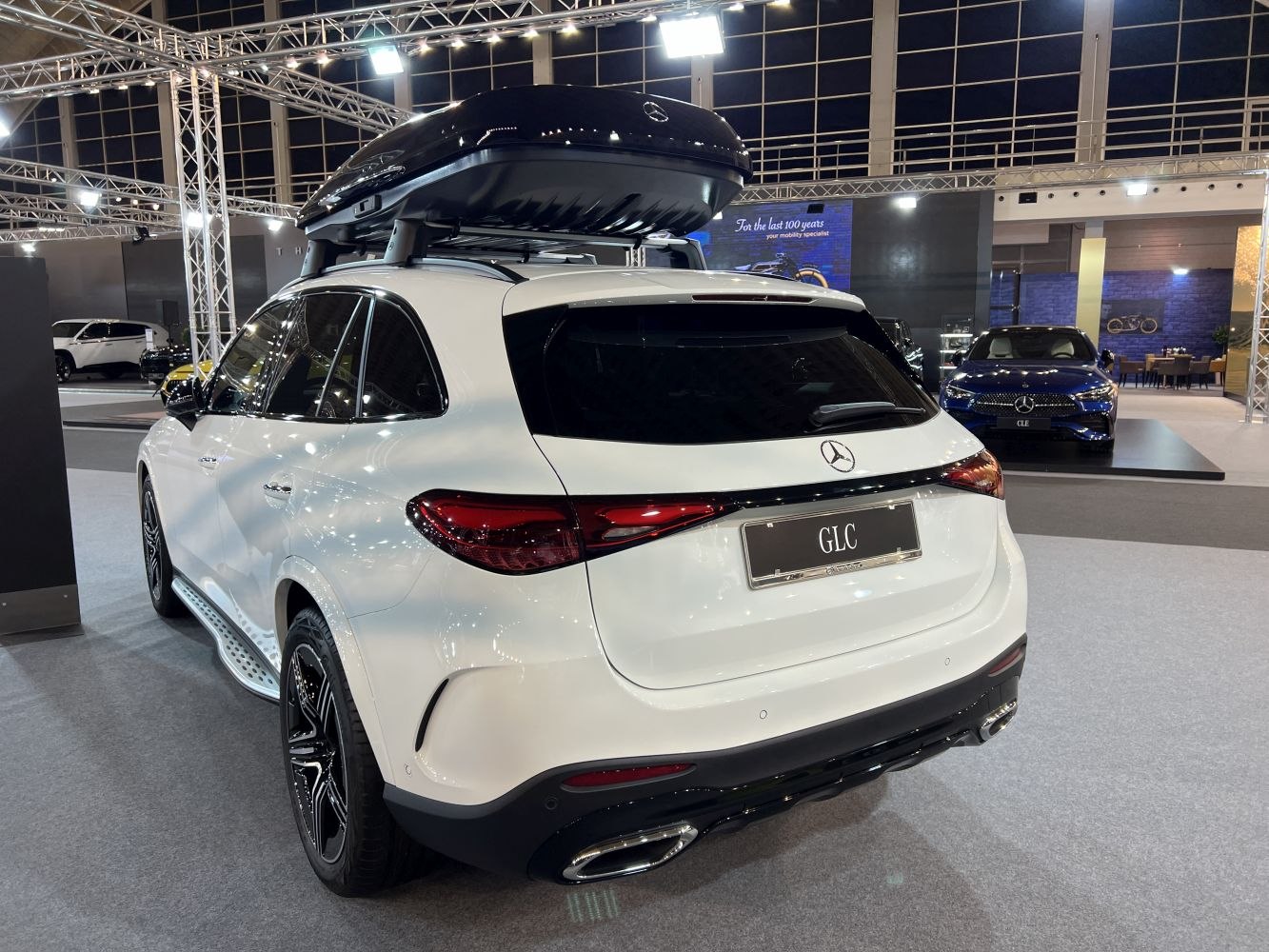 Rear view of SUV with roof cargo box and dual exhaust pipes