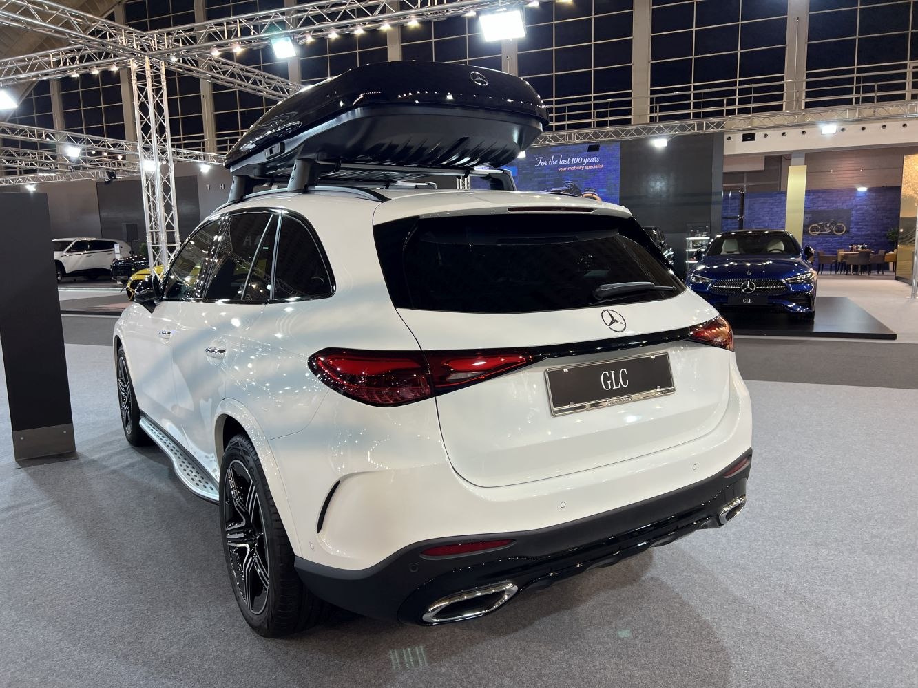 Rear side of luxury SUV with roof cargo box and dual exhausts