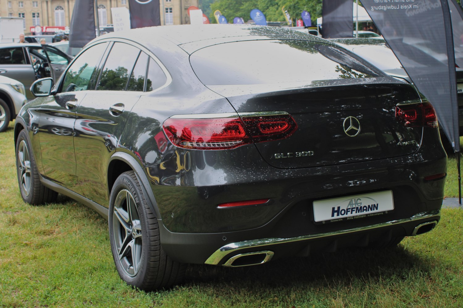 Rear view of a sleek luxury SUV with tinted taillights and dual exhaust outlets.
