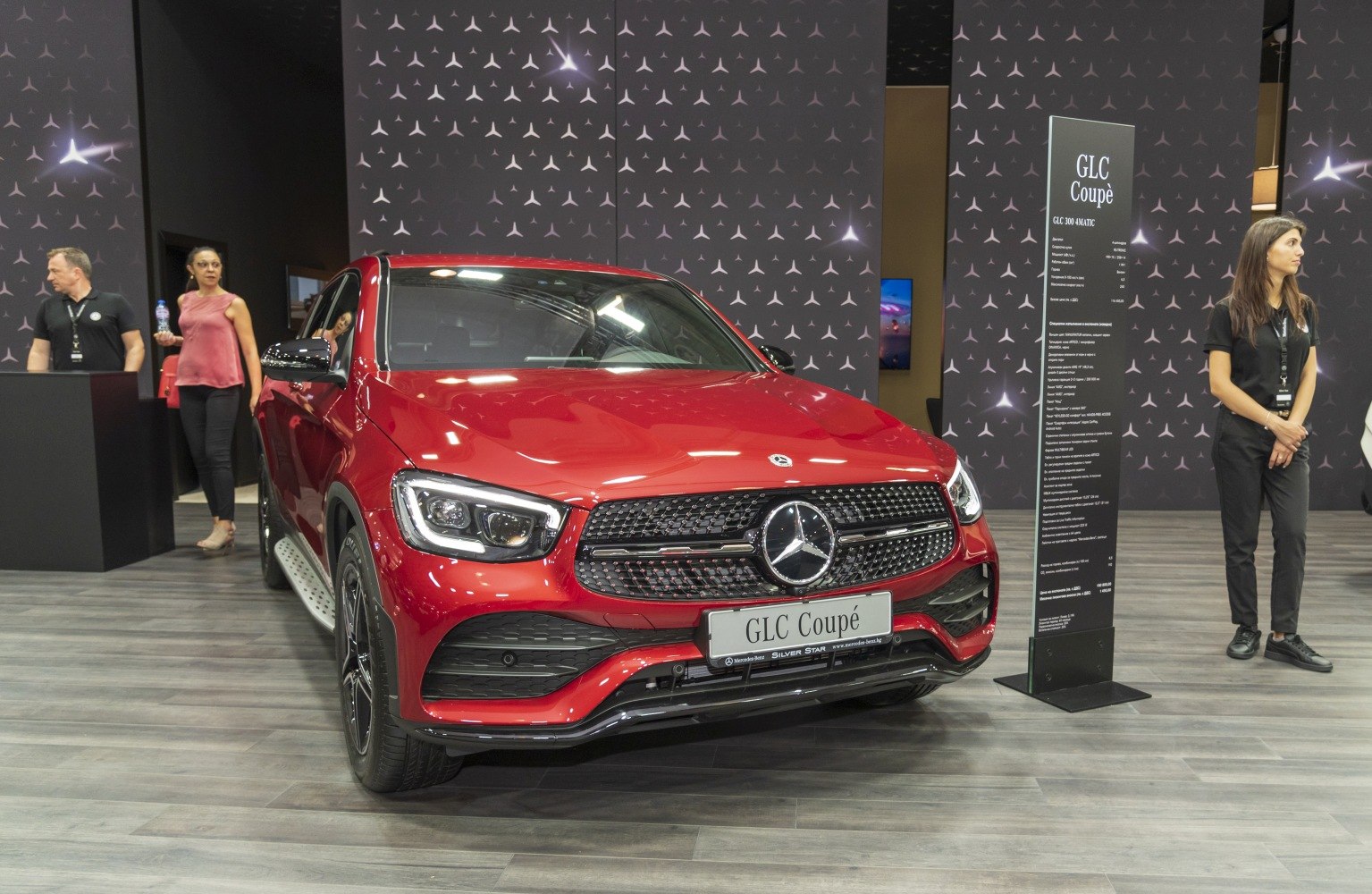 Red SUV front with distinctive grille and LED headlights