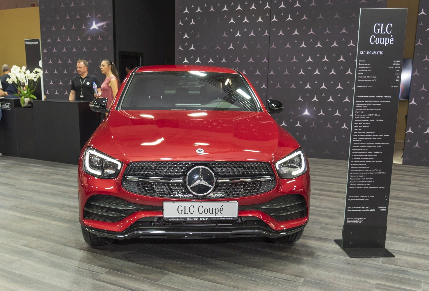 Front view of a red SUV with AMG style grille and LED headlights