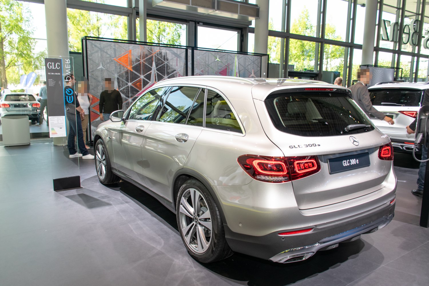 Rear view and LED taillights of a luxury silver SUV in showroom