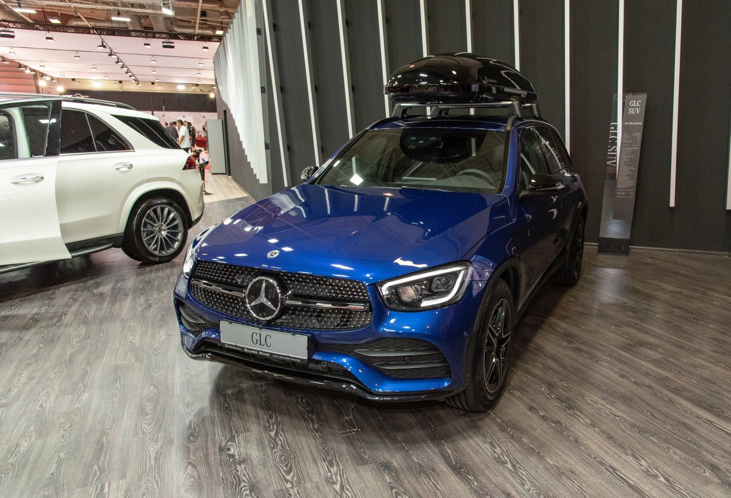 Modern SUV with LED headlights and a roof-mounted cargo box