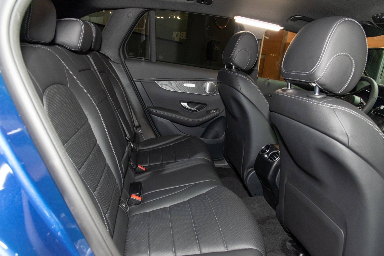 Black leather rear seats with detailed stitching and rear air vents