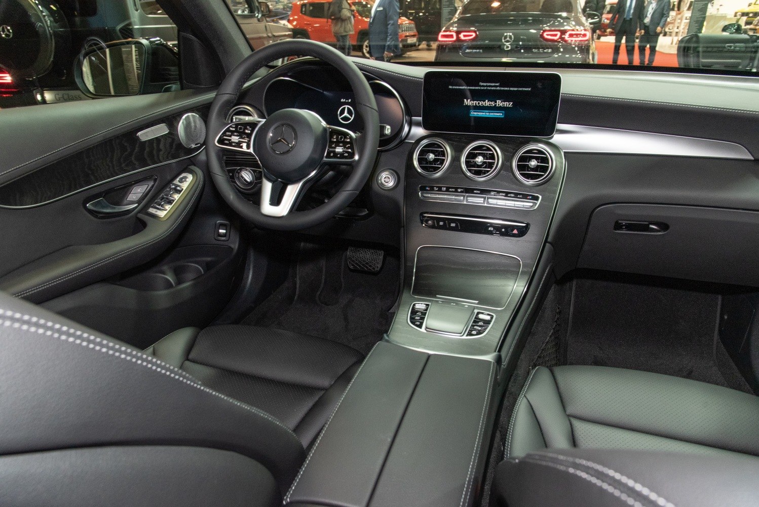 Interior dashboard and steering wheel with central infotainment of luxury SUV