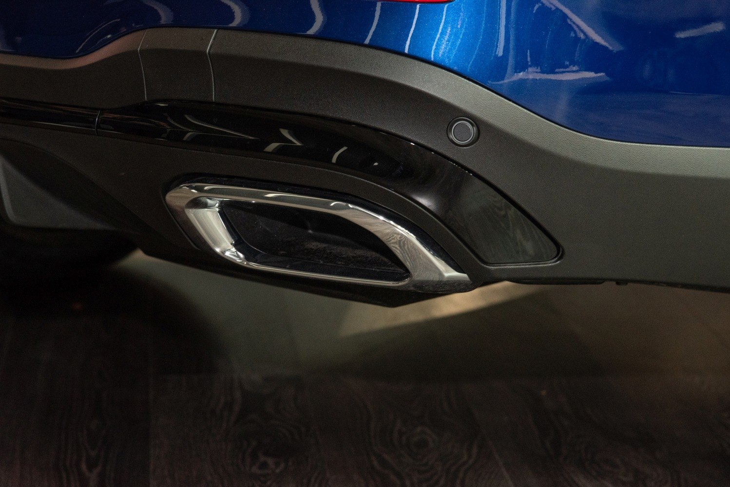 Close-up of chrome exhaust tip and rear bumper detail