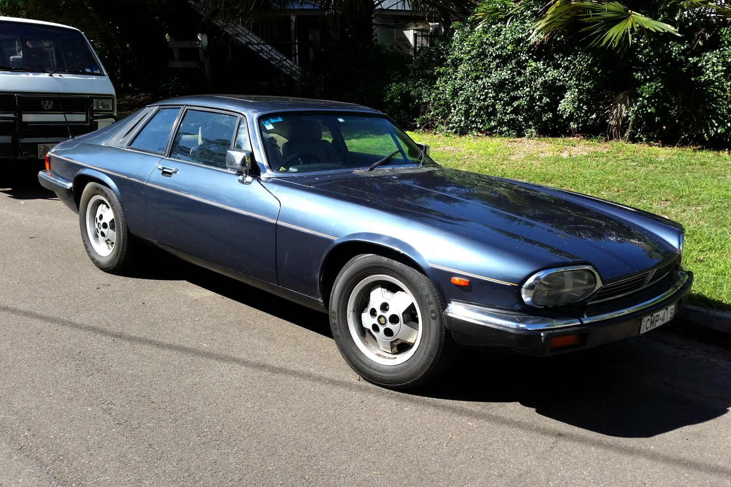 Aerodynamic vintage two-door coupe with long hood and distinctive front design.