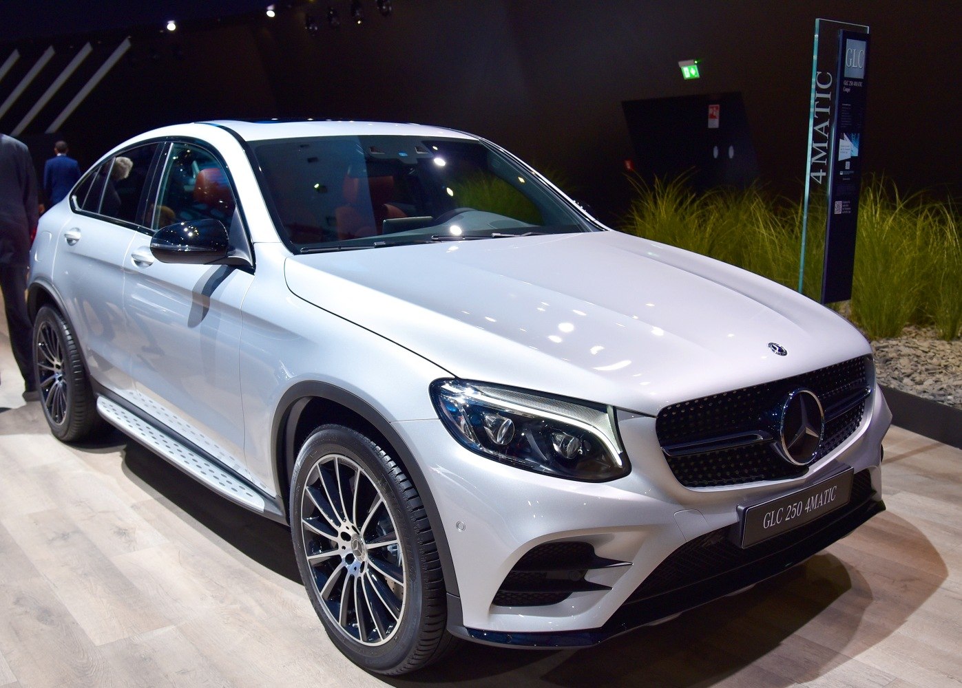 Front-side view of a luxury coupe SUV with LED headlights and alloy wheels