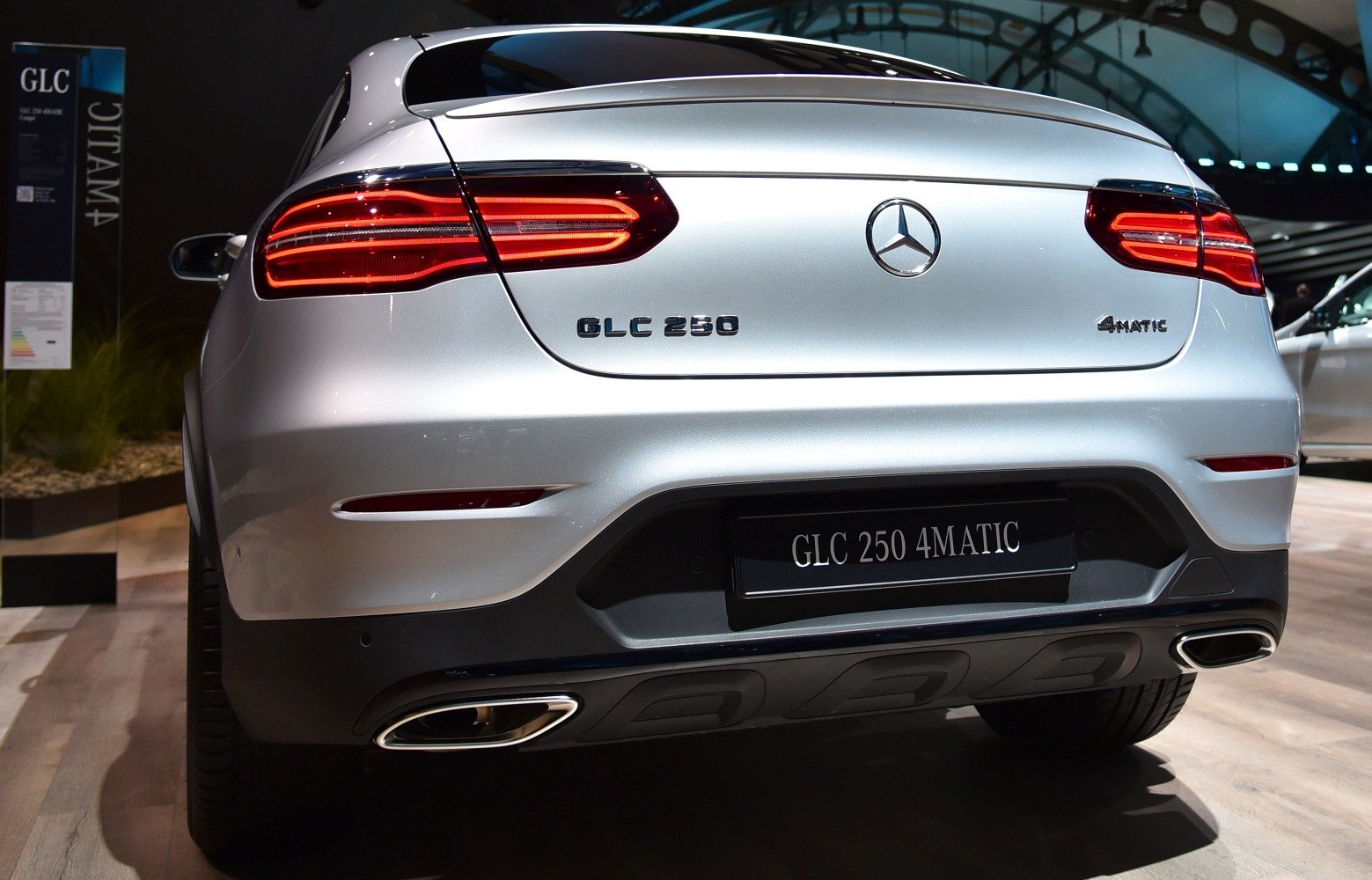 Rear tail lights and dual exhaust tips of a vehicle