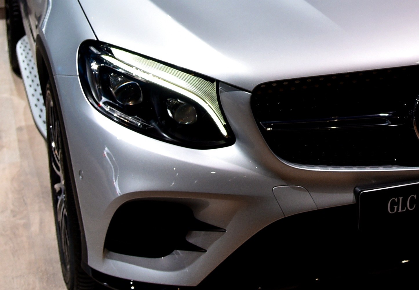 LED headlight and black front grille close-up