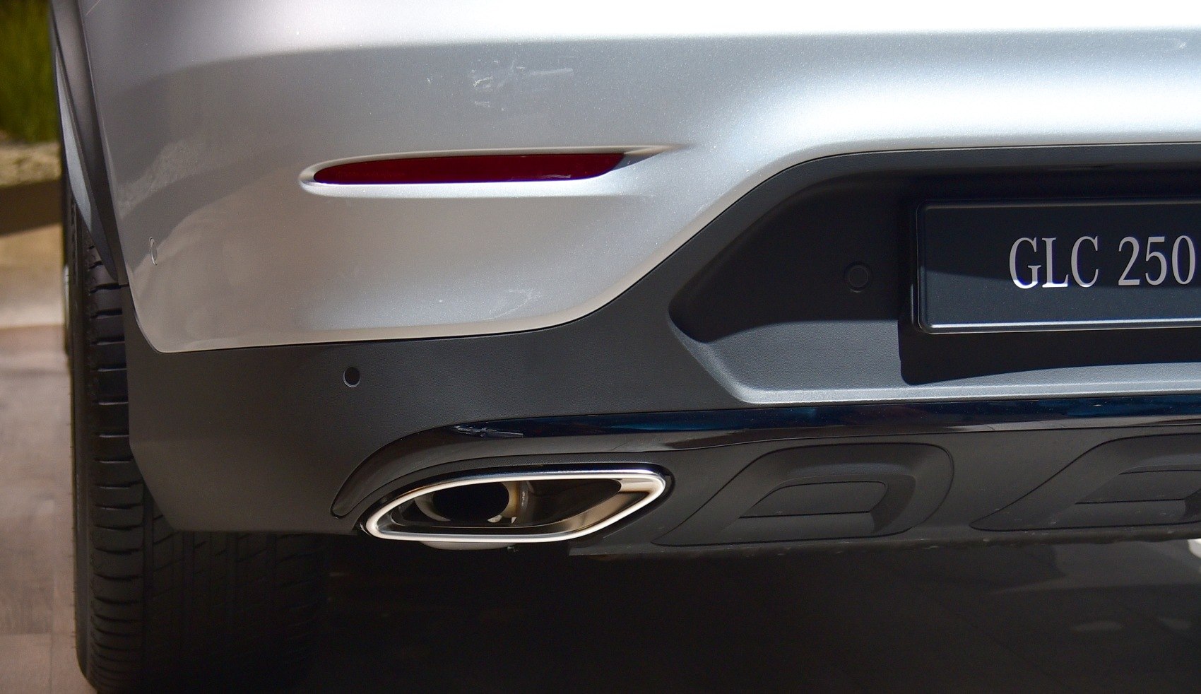 Rear exhaust pipe and bumper with rear reflector in close-up