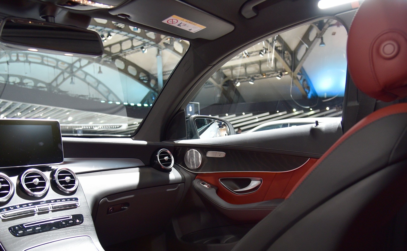 Red leather seats, circular air vents, modern dashboard with infotainment screen