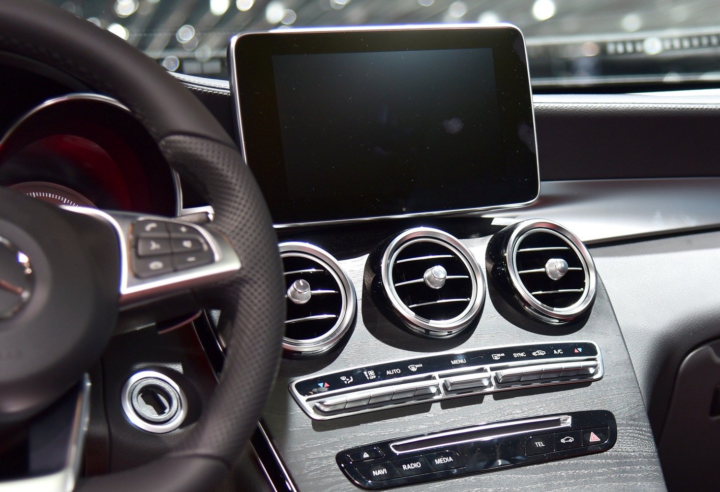 Dashboard with circular vents and a central infotainment screen