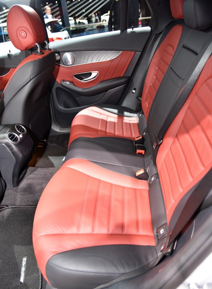 Rear interior with two-tone red and black leather seats and modern door panel.