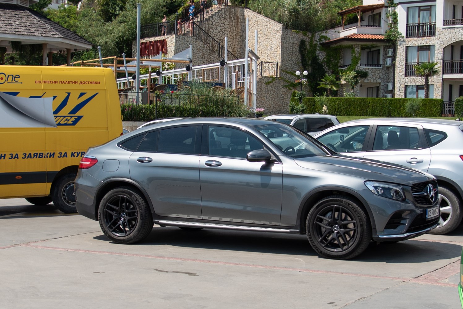 Coupe SUV with sloping roofline, black alloy wheels, tinted windows