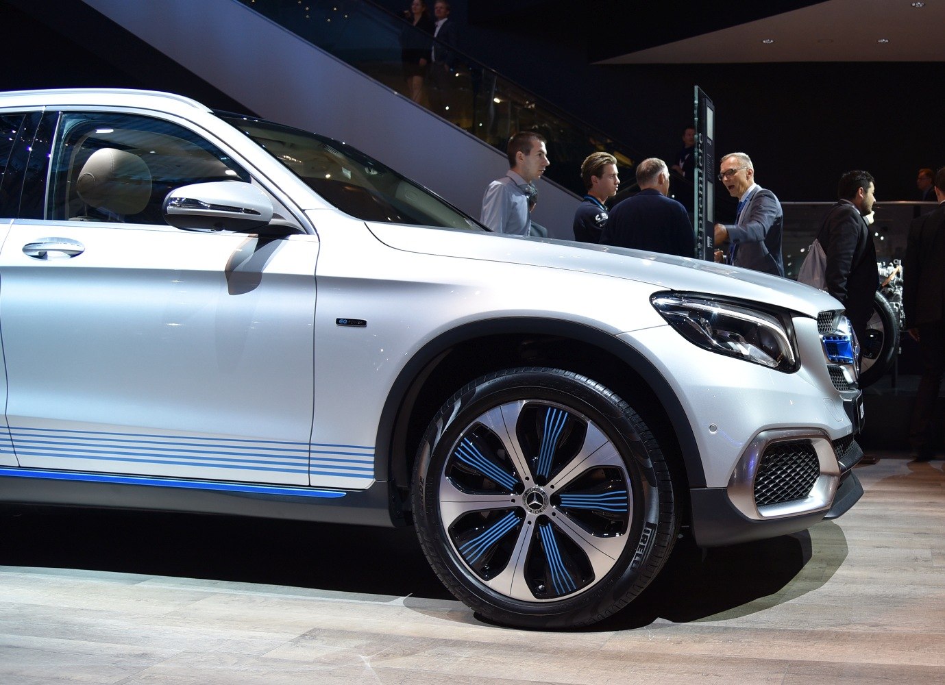 Front-side view with electric blue-striped alloy wheel and LED headlight