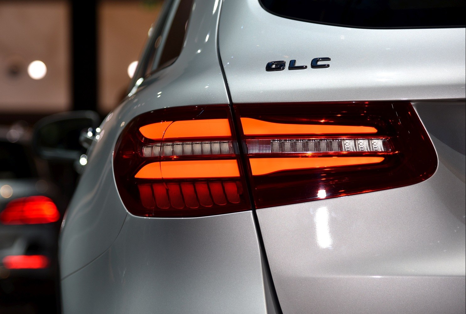 Close-up of rear LED taillight and model badge on a silver SUV