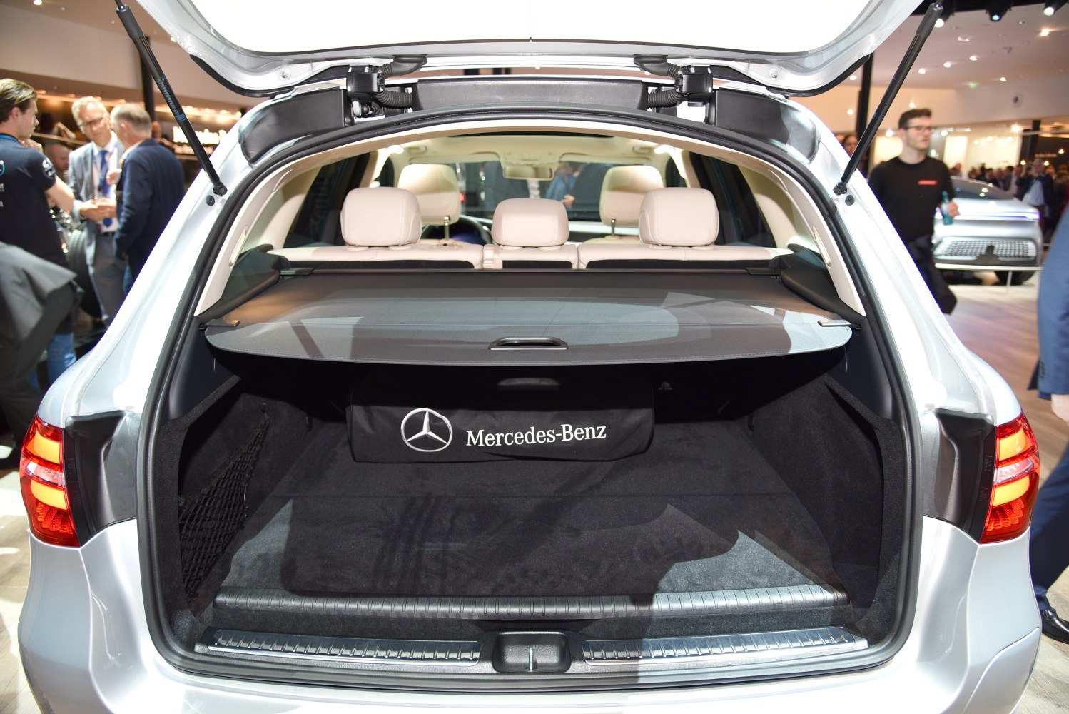 Open trunk space with retractable cargo cover and beige rear seats