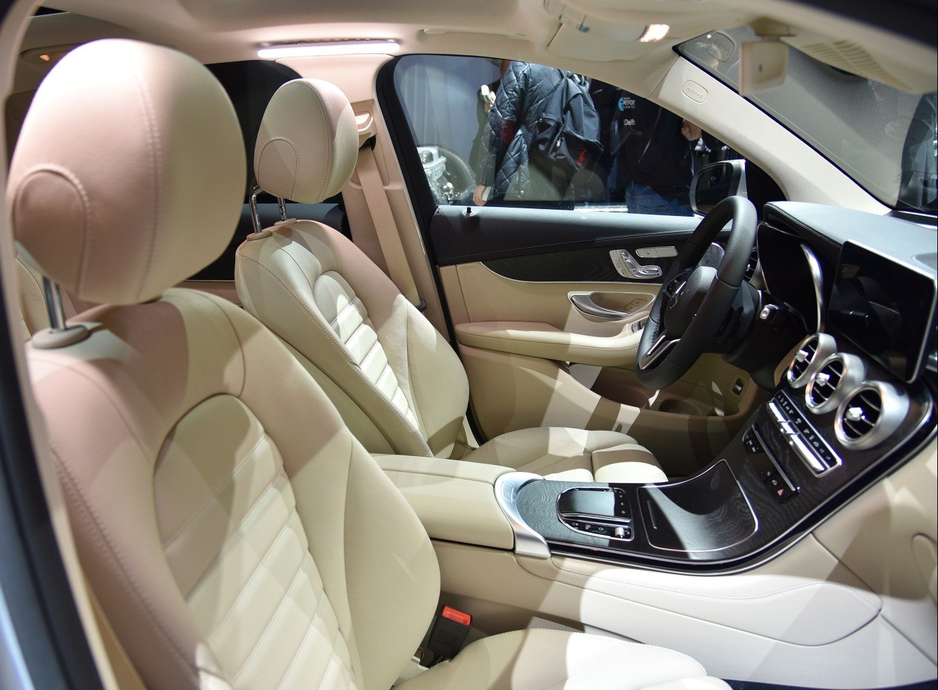 Beige leather front seats and modern dashboard with center console